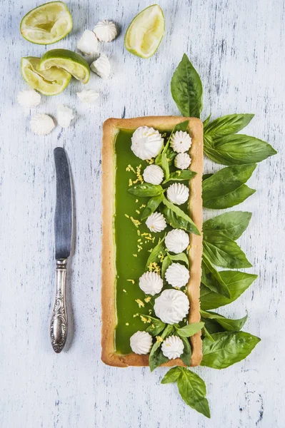 Cake with jelly from basil with French meringue and lemon zest.