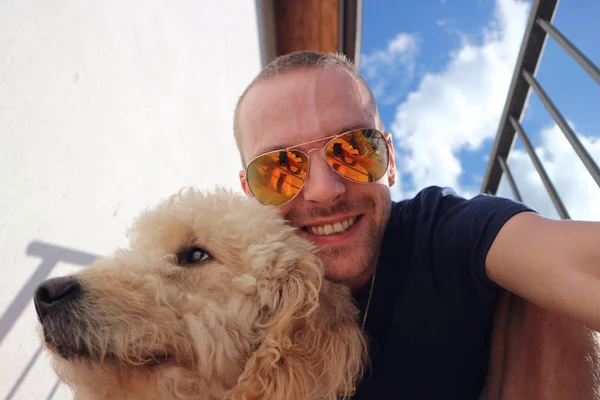 Happy man with pet dog making selfie