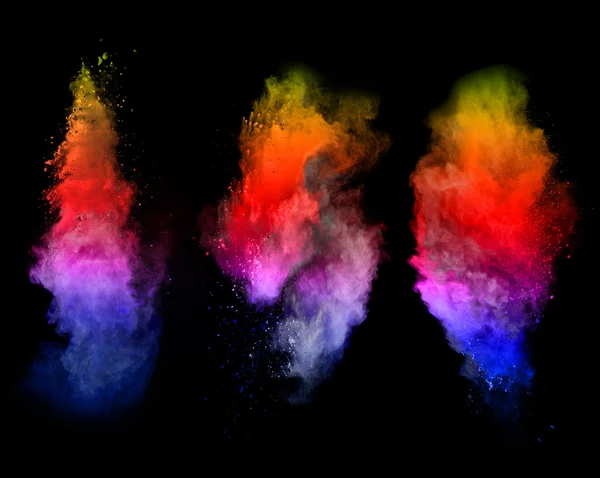 Explosion of colored powders on black background — Stock Photo, Image