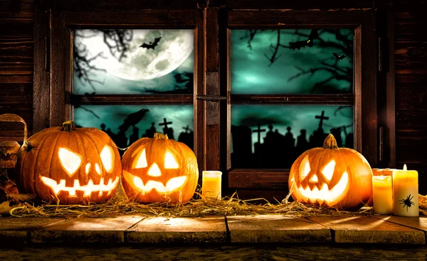 Scary halloween pumpkins on wooden planks — Stock Photo, Image