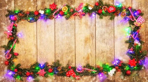 Christmas colored lights with decoration on wood — Stock Photo, Image