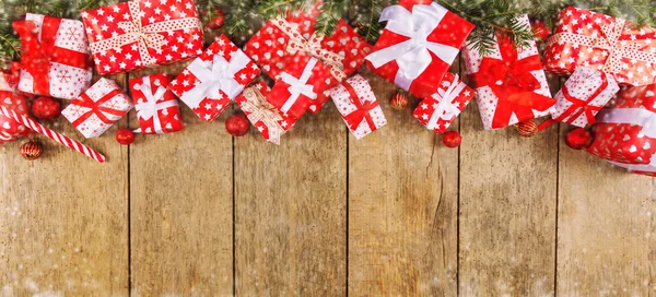 Christmas gift boxes placed on wooden planks — Stock Photo, Image