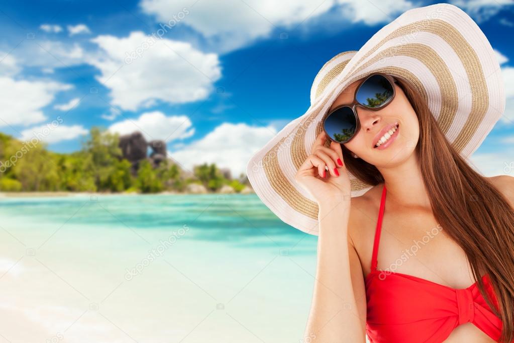 Beautiful woman's portrait over beach background