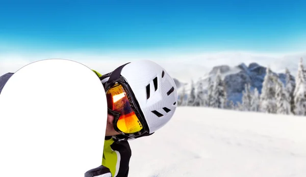 Snowboarder holding his snowboard off piste — Stock Photo, Image