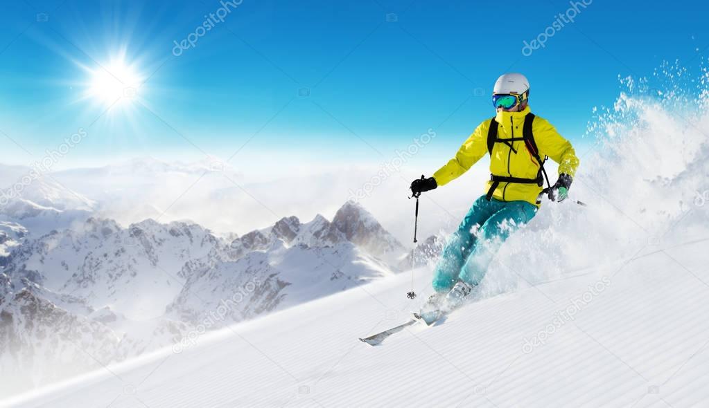 Skier on piste running downhill