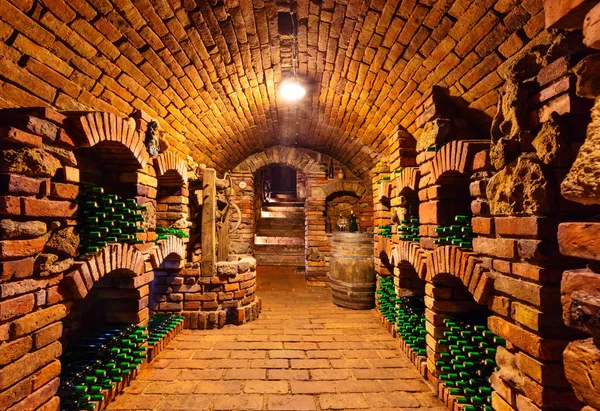 Small wine cellar with bottles and keg — Stock Photo, Image