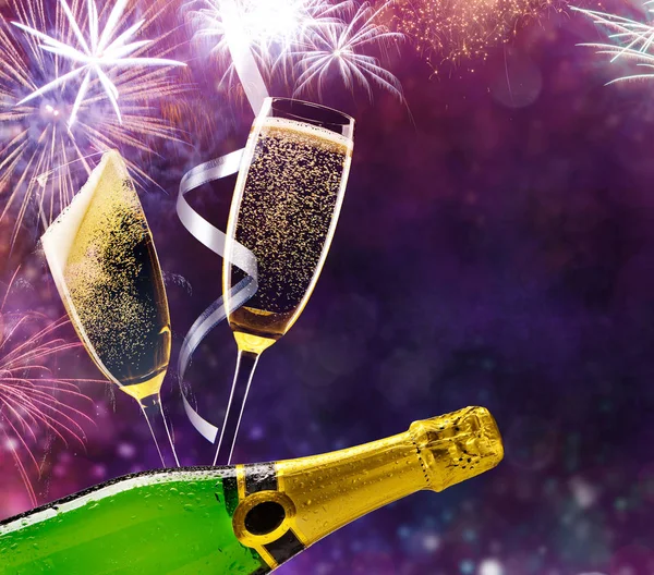 Bottle of champagne with glasses over fireworks background — Stock Photo, Image