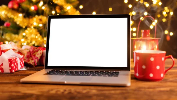 Laptop on wooden table with Christmas background