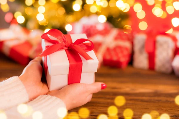 Detail of woman hands holding Christmas gift — Stock Photo, Image