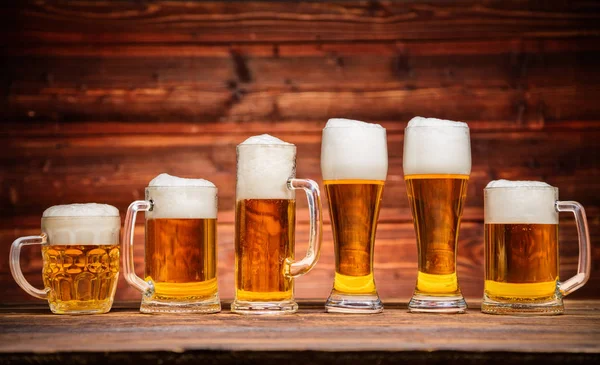 Glasses of lager served on old wooden planks — Stock Photo, Image