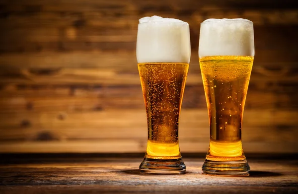 Glasses of lager served on old wooden planks, — Stock Photo, Image