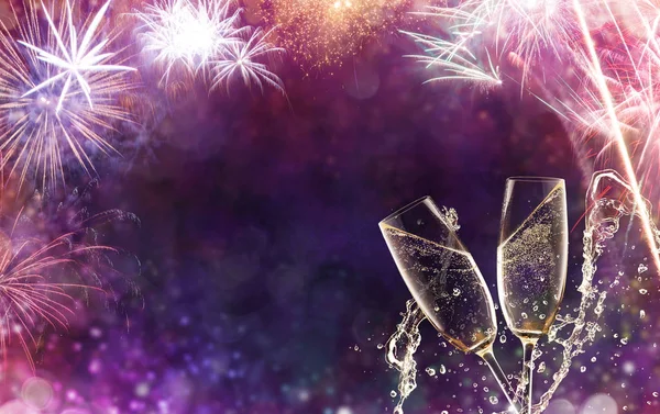 Two glasses of champagne over fireworks background — Stock Photo, Image