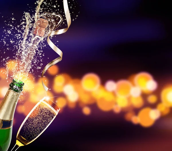 Bottle of champagne with glass over blur background — Stock Photo, Image