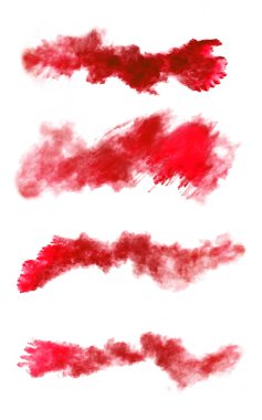 Freeze motion of red dust explosions on white background clipart