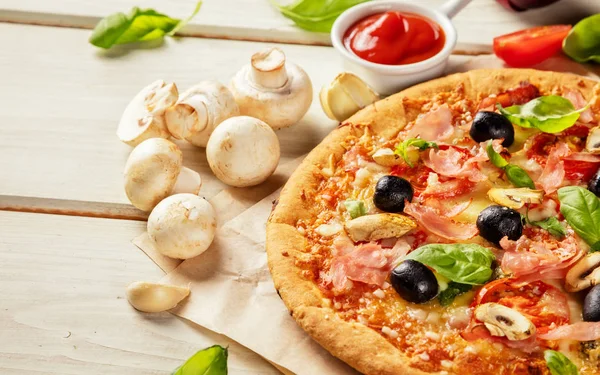 Pizza with ingredients served on wood — Stock Photo, Image