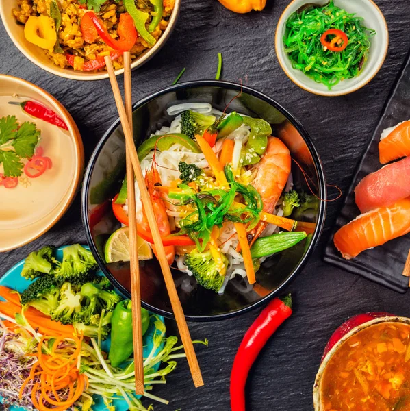 Asian food served on black stone, top view — Stock Photo, Image