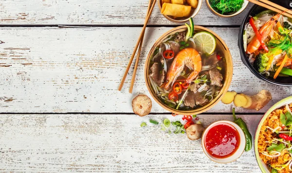 Asian food served on wooden table, top view, space for text — Stock Photo, Image