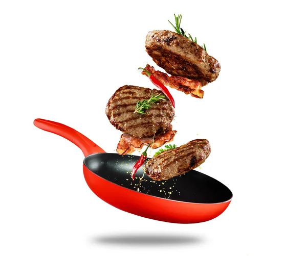 Beef milled meat flying from a pan on white background — Stock Photo, Image