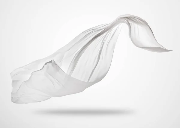 Hladká elegantní bílý ubrus na šedém pozadí — Stock fotografie