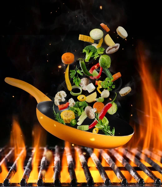 Fresh vegetable flying above grill — Stock Photo, Image