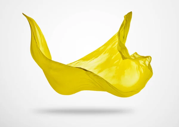 Гладкая элегантная желтая ткань на сером фоне — стоковое фото