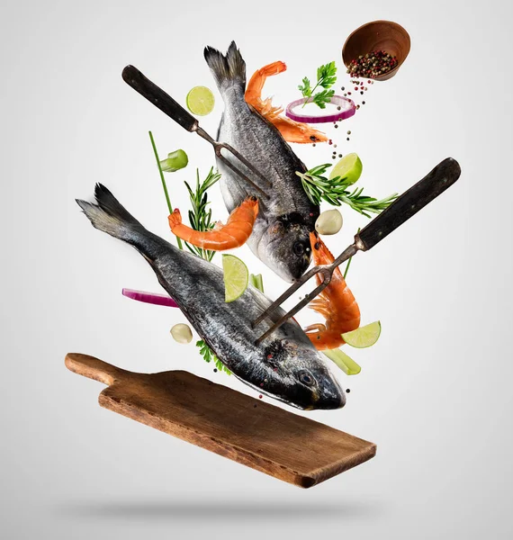 Flying raw whole bream fish and prawns with ingredients — Stock Photo, Image