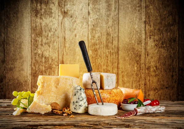 Various kind of cheese served on wood — Stock Photo, Image