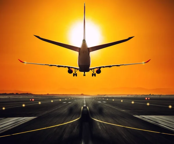 Silhouette from a landing airplane at the runway. — Stock Photo, Image