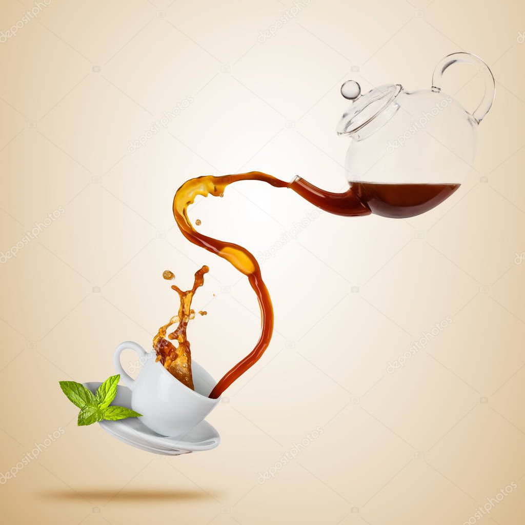 Porcelaine white cup with splashing tea, separated on brown background.