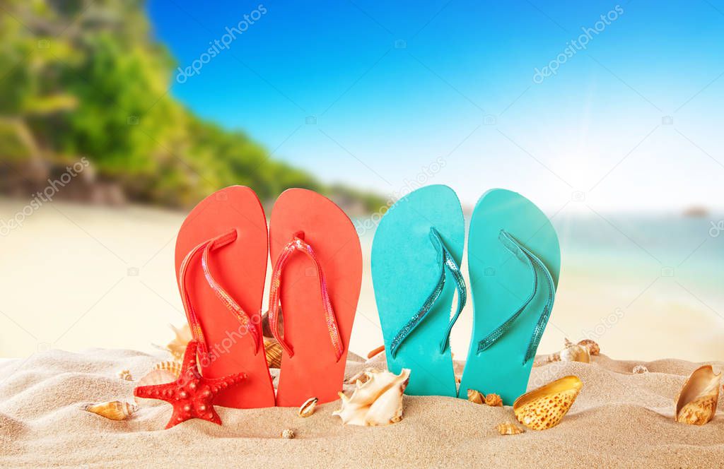 Tropical beach with colored flip flops, summer holiday backgroun