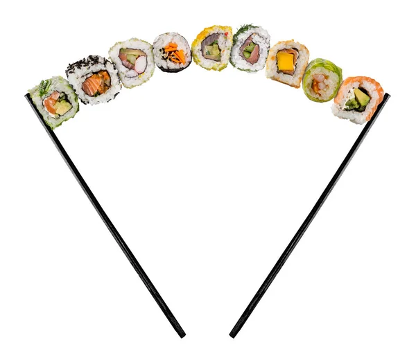 Sushi pieces placed between chopsticks on white background — Stock Photo, Image