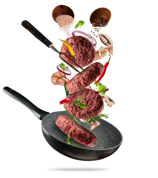 Flying raw hamburger meats with ingredients on white background — Stock Photo, Image