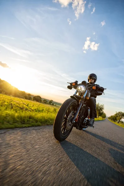 日没のハイパワー バイクに乗って暗いライディング — ストック写真