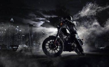 High power motorcycle chopper with man rider at night clipart