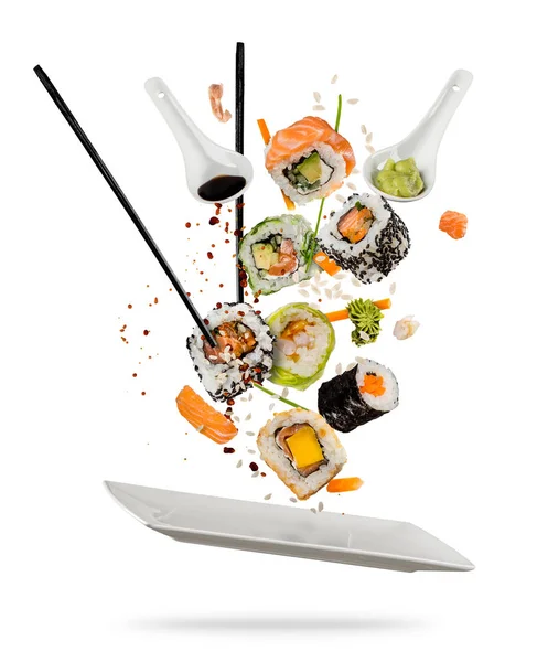 Sushi pieces placed between chopsticks on white background — Stock Photo, Image