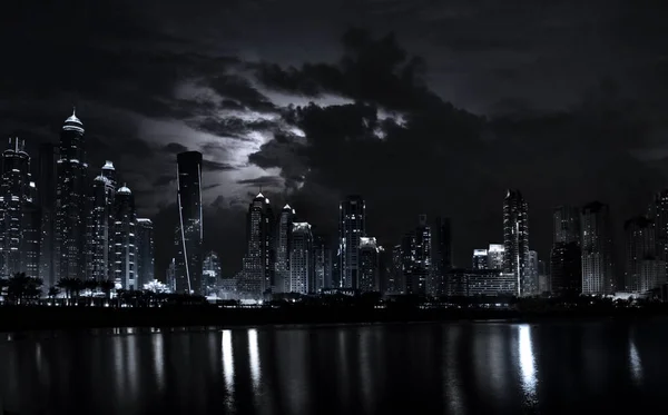 Night scene of modern Dubai Marina with dramatic sky — Stock Photo, Image