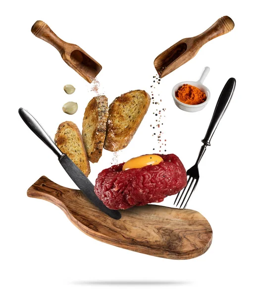 Flying tartar steak with spice and toasts. Concept of flying foo — Stock Photo, Image