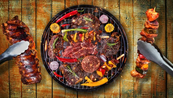 Top view of fresh meat and vegetable on grill placed on wooden p — Stock Photo, Image