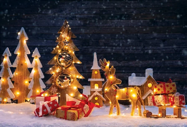 Christmas backgound with illuminated wooden village and christma — Stock Photo, Image