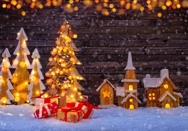 Christmas background with illuminated wooden village and christm — Stock Photo, Image