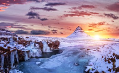 Kirkjufell mountain with frozen water falls in winter, Iceland. clipart
