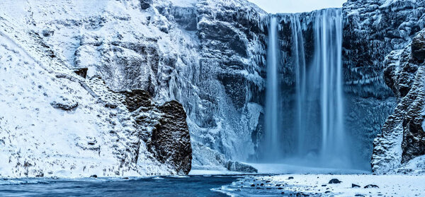 Beautiful panoramic photo of Skogafoss waterfall in winter, Icel