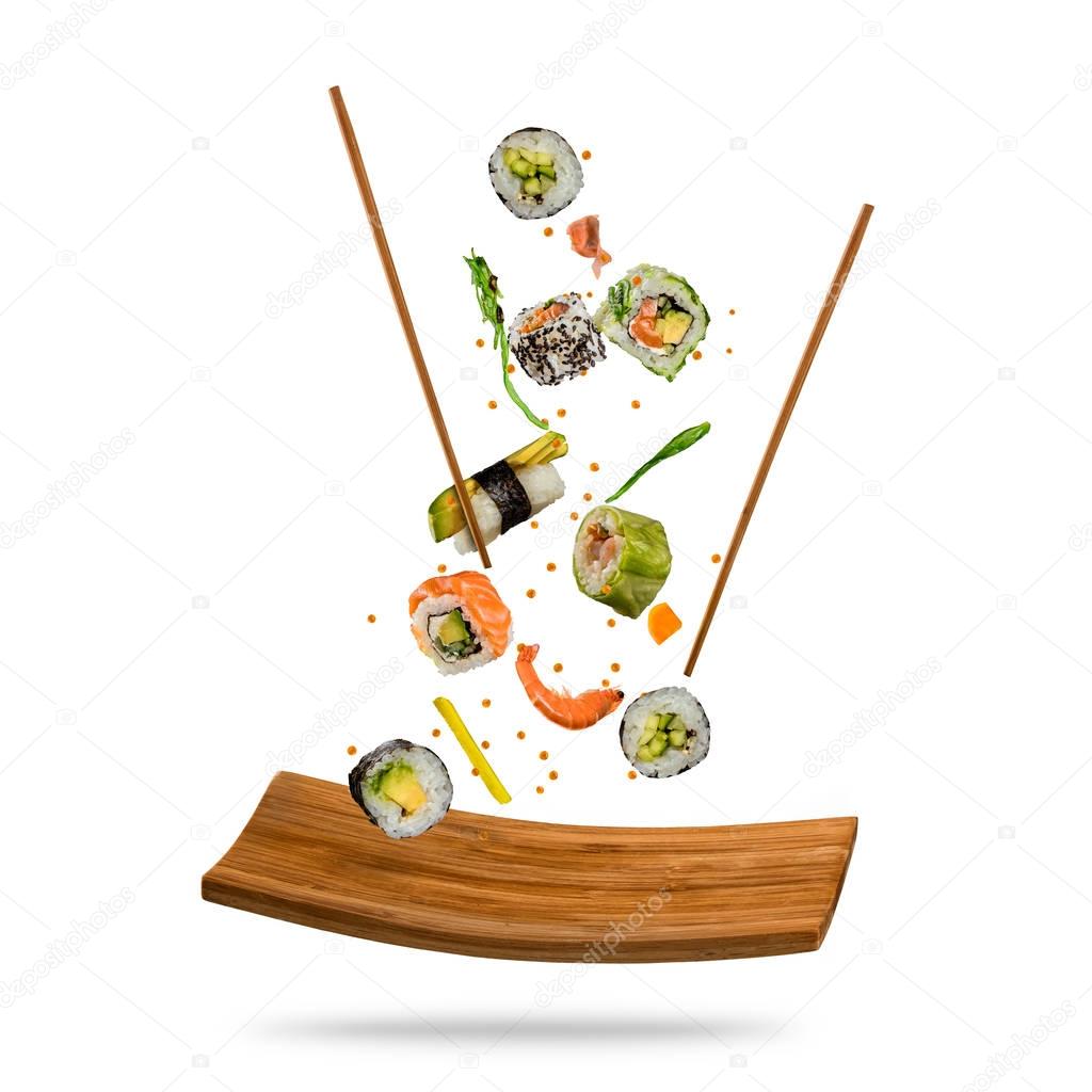 Flying pieces of sushi isolated on white background