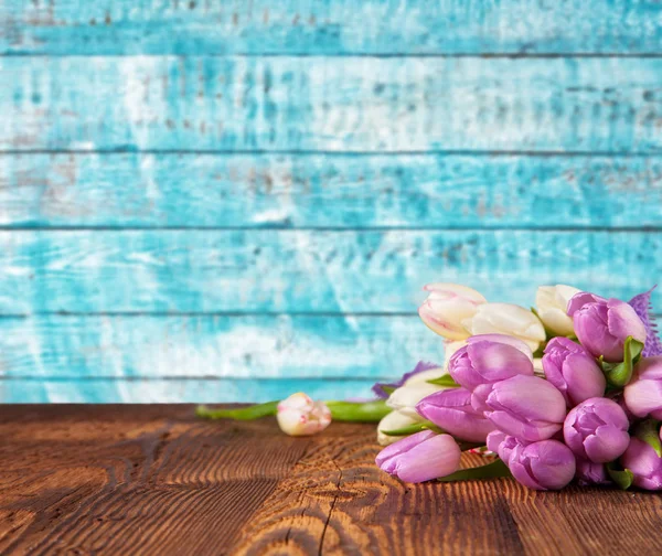 Bouquet of colored tulips placed on vintage wooden planks — Stock Photo, Image