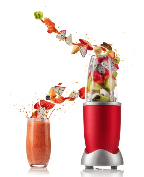 Smoothie mixer with drink and fruit flying ingredients on white — Stock Photo, Image