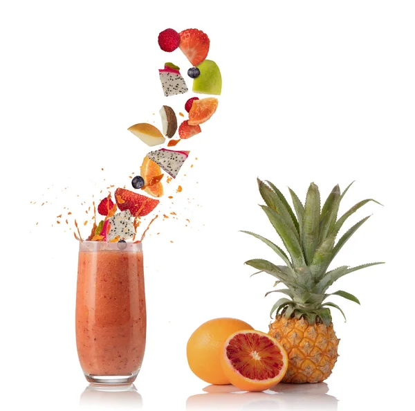 Smoothie drink with fruit flying ingredients on white — Stock Photo, Image