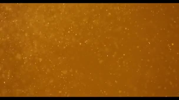 Mouvement lent de particules réalistes sur fond doré 