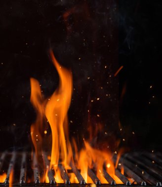 Empty flaming charcoal grill with open fire with copyspace. clipart