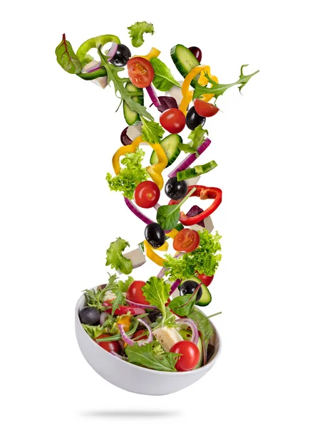 Flying vegetable greek salad isolated on white background Royalty Free Stock Photos