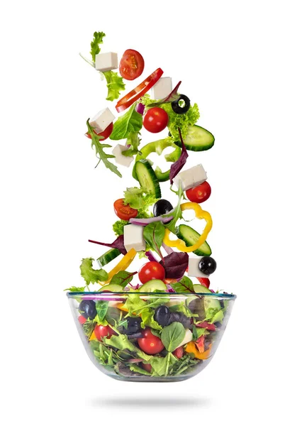 Flying vegetable greek salad isolated on white background Stock Image